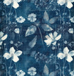 Vintage botanical floral art featuring white flowers and leaves on a deep blue cyanotype background with overlayed vintage French script and decorative paper elements.