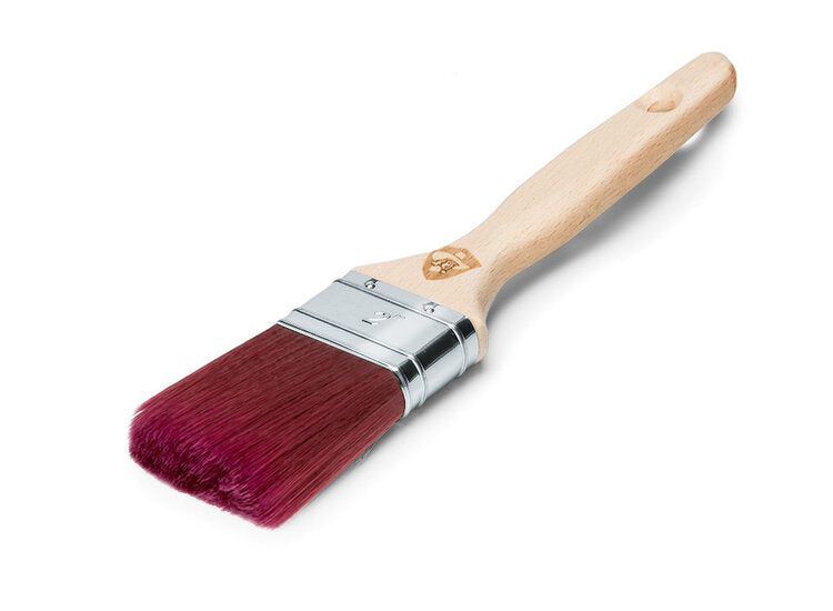 A high-quality flat paintbrush with a natural wood handle and magenta-colored bristles. The metal ferrule secures the bristles to the handle. The brand is Staalmeester.